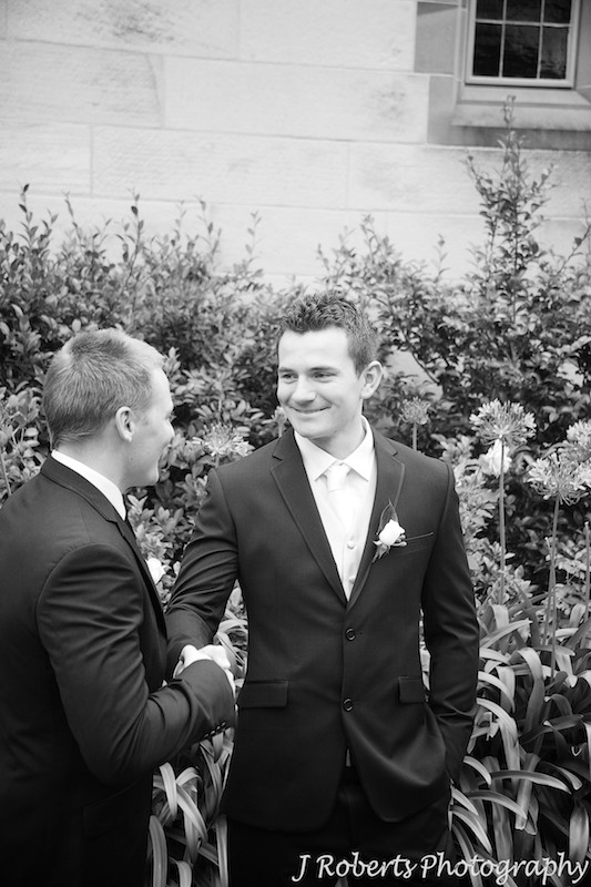 Groom being congratulated by best man - wedding photography sydney